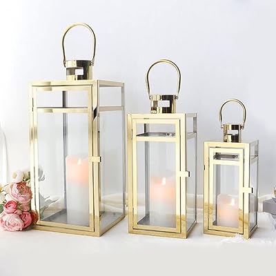 Tri Rockx Set of 3 stainless steel lanterns - matching sizes (12/15/19 inches) - High metal hanging lanterns with transparent glass panels, interior and exterior decoration for celebrations and events - Golden finish.. DIAYTAR NIGERIA connects you with endless possibilities through our affordable e-commerce platform.