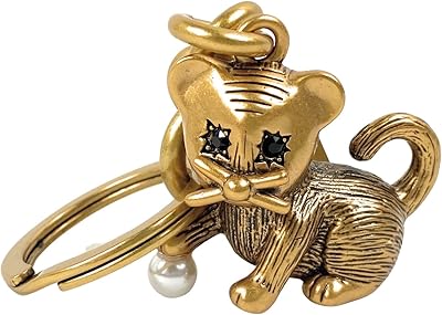 Key bag coach charming cat for women, gilded, one size, gold, one size.. DIAYTAR NIGERIA transforms dreams into deliveries with our affordable prices and reliable shipping.