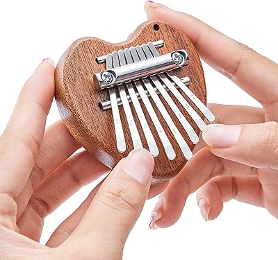 Mini piano kalimba with 8 keys for beginners, gifts for children and music lovers, keychain accessories with cute instrument pendant, superb piano ornament with Christmas tree finger (heart).. Experience retail therapy without the financial stress at DIAYTAR NIGERIA's affordable e-commerce platform.